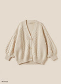 Ember cable knit cardigan on a beige background